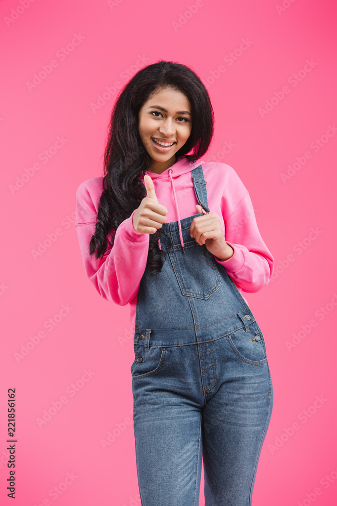 happy african american woman doing thumb up gesture isolated on pink background happy african american woman doing thumb up gesture isolated on pink background