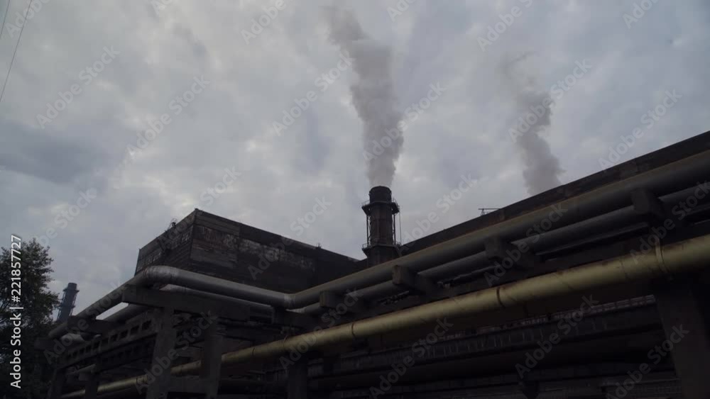 A big stovepipe smokes on the mining and processing plant. aerial shooting 4K A big stovepipe smokes on the mining and processing plant. aerial shooting 4K