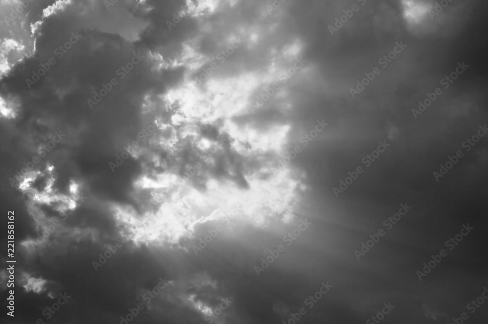 sunbeam spreading light through dark cloud on sky sunbeam spreading light through dark cloud on sky