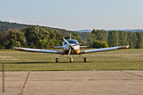 small airplane with a propeller at the airport