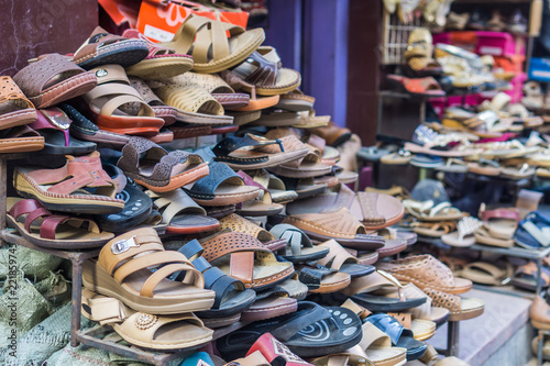Pile of shoes and sandals in a traditional marketplace in South Asia