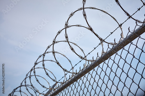 Razor barbed wire against the sky, imprisonment concept.