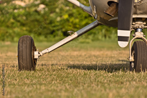 chassis of sport aircraft and green grass