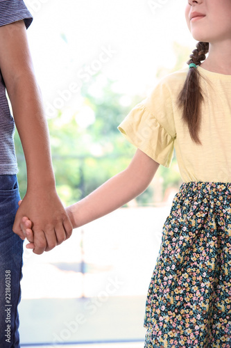 Children holding hands on blurred background. Unity concept