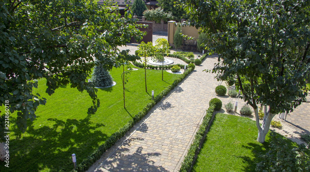 Cobbled concrete paving slab track in a beautifully manicured garden Cobbled concrete paving slab track in a beautifully manicured garden