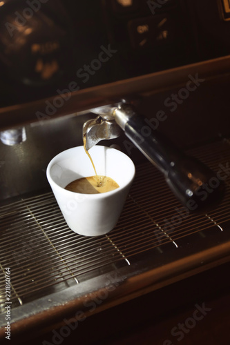 Preparing fresh aromatic coffee on modern machine  closeup
