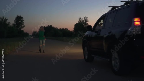 Blond girl unsuccessfully trying to stop car