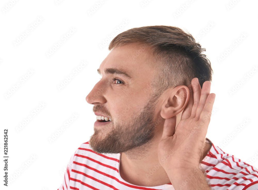 Obraz premium Young man with hearing problem on white background