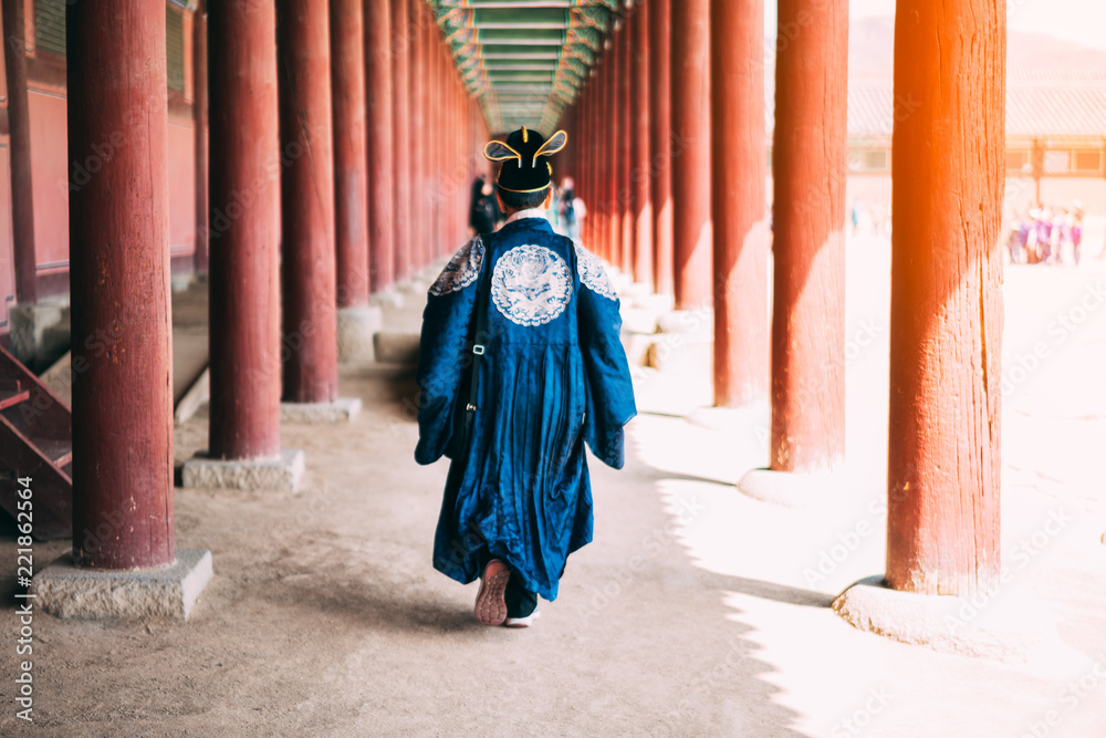 Traveler man in korean national costume walking traveling into the Gyeongbokgung Palace at Seoul city, South Korea. Traveler man in korean national costume walking traveling into the Gyeongbokgung Palace at Seoul city, South Korea.