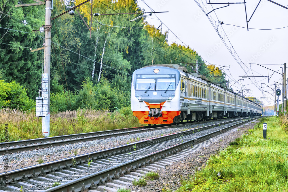 Obraz premium The electric train drives at high speed at the station