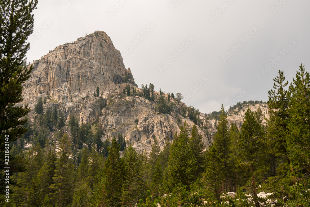 Wide granite valleys under stormy skies in California's Sierra Nevada