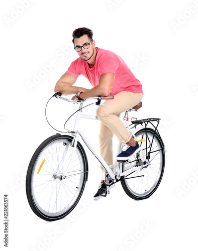 Handsome young hipster man with bicycle on white background