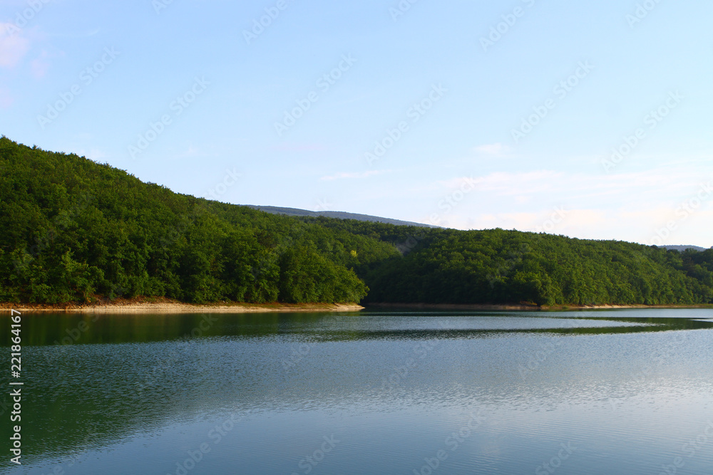 Natural landscape photo - wonderful still lake with green hills in distance