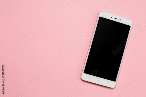 Smartphone with blank screen on pink background.