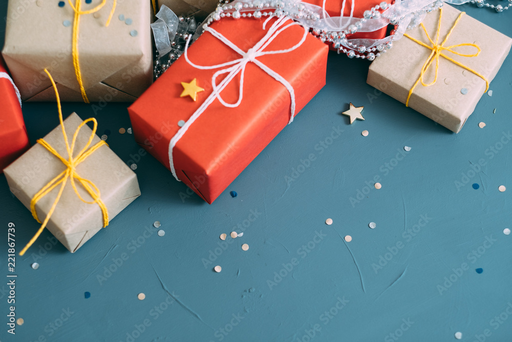 holiday celebration festive background. assortment of presents wrapped in red and craft paper. gift boxes mix with silver bead strings and confetti decor. free space holiday celebration festive background. assortment of presents wrapped in red and craft paper. gift boxes mix with silver bead strings and confetti decor. free space