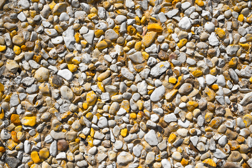 Gravel with white and yellow pebbles/texture background photo