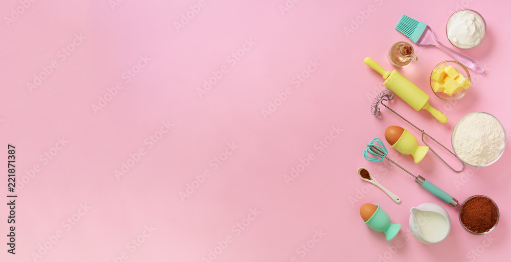 Banner of baking ingredients - butter, sugar, flour, eggs, oil, spoon, rolling pin, brush, whisk, towel over pink background. Bakery food frame, cooking concept. Top view, copy space. Flat lay Banner of baking ingredients - butter, sugar, flour, eggs, oil, spoon, rolling pin, brush, whisk, towel over pink background. Bakery food frame, cooking concept. Top view, copy space. Flat lay