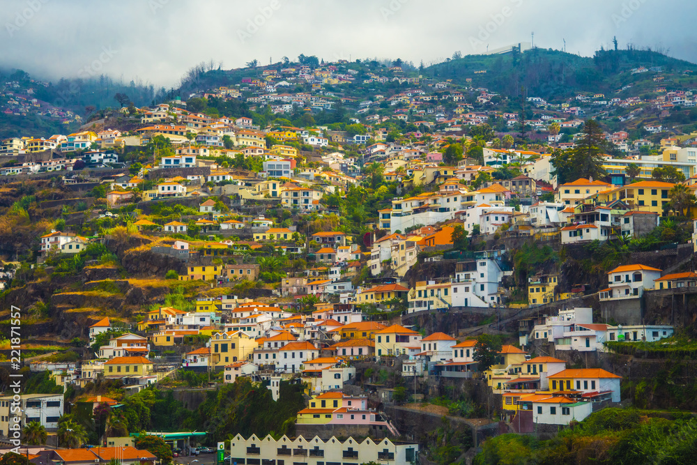 Fototapeta premium Houses with tiled roofs on the mountainside.