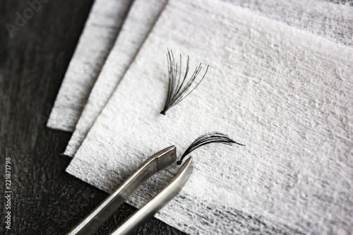 False black eyelashes with tweezers on cotton