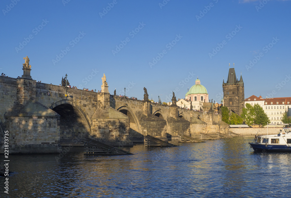 View of Charles Bridge in Prague, Czech Republic. Gothic Charles Bridge is one of the most visited sights in Prague. Architecture and landmark of Prague, golden light, sunny summer day
