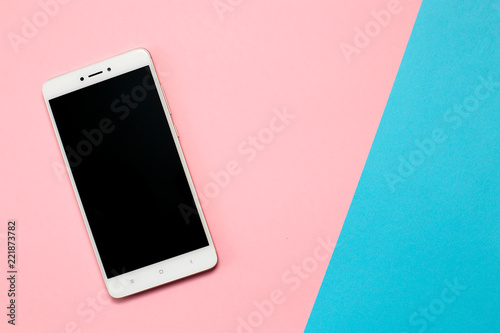 Smartphone with blank screen on pink background.