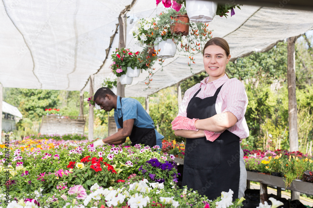 Florist girl working in greenhouse