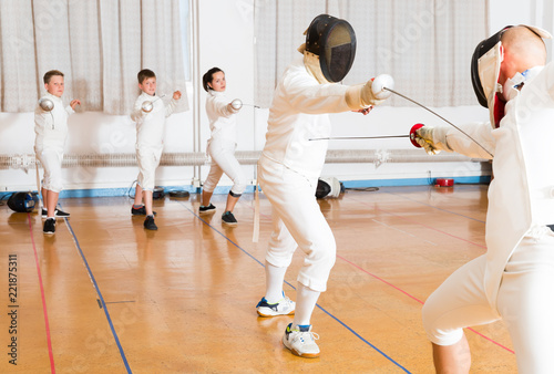 adults and teenagers athletes at fencing coaching © JackF