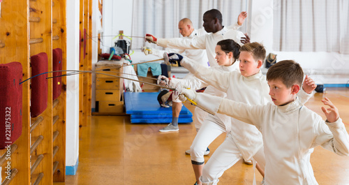 Happy group of athletes at fencing workout photo