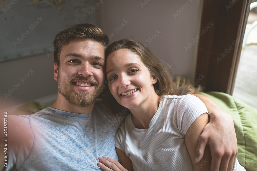 Couple sitting together with arm around Couple sitting together with arm around
