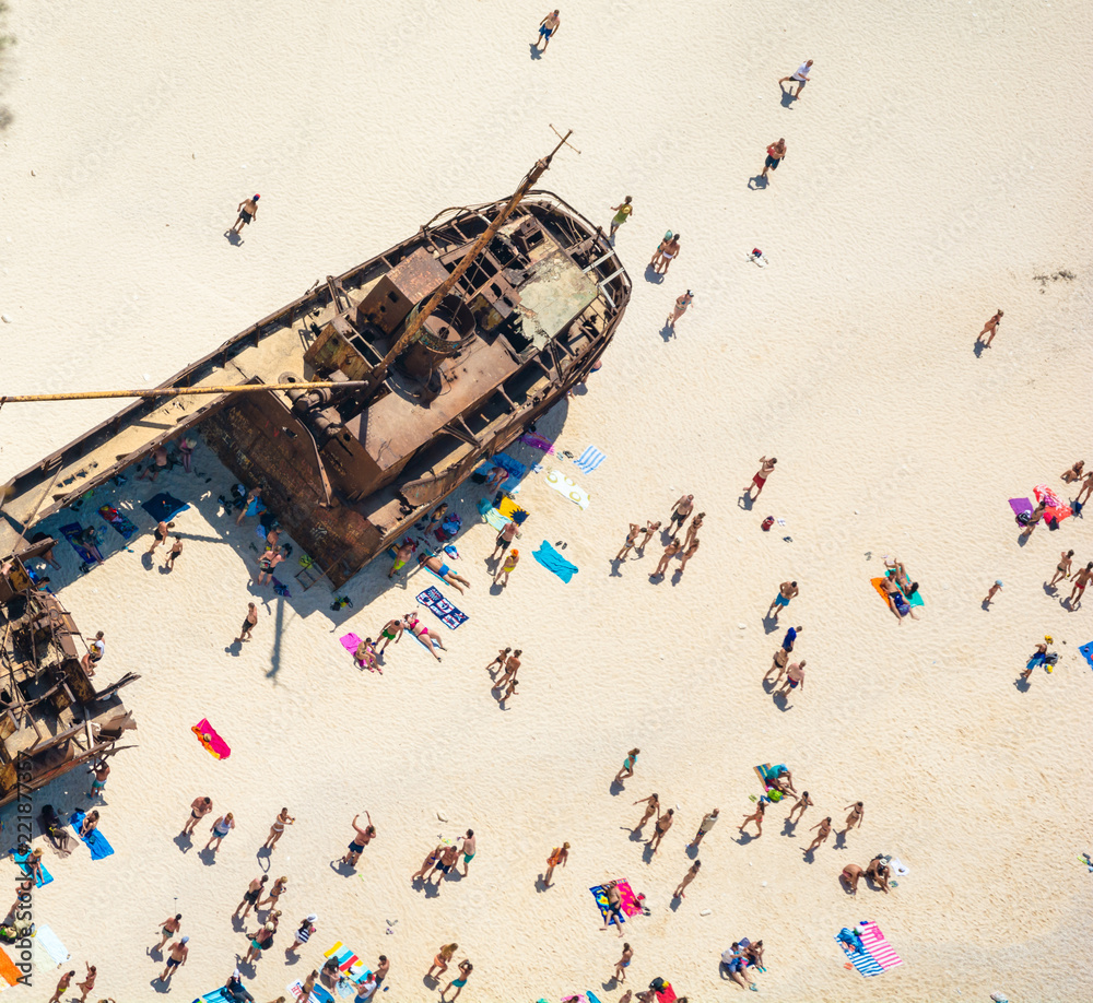 people and shipwreck on Navagio beach, Zakynthos, Greece