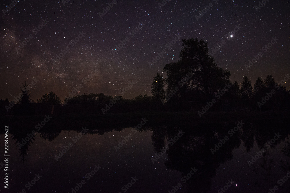 Reflection of stars and trees in the pond at night Reflection of stars and trees in the pond at night
