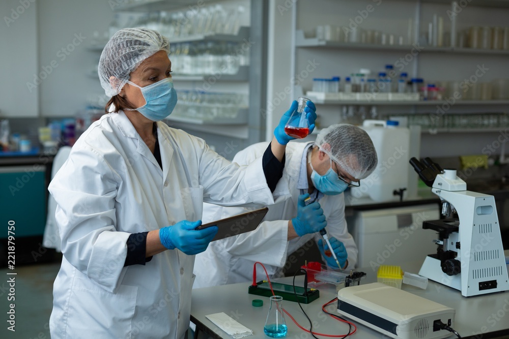 Scientists experimenting in laboratory Scientists experimenting in laboratory