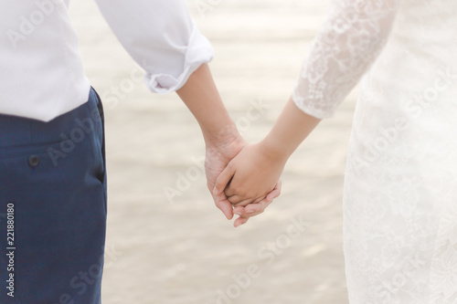 love couple holding hands on the beach