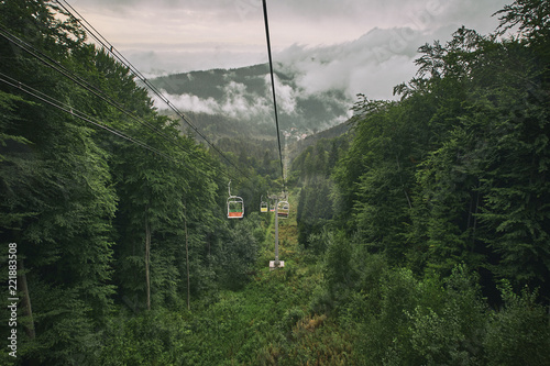 misty mountains and cableway in the deep forest