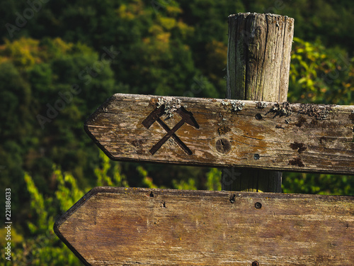 Rustic wooden sign with crossed hammers and copyspace