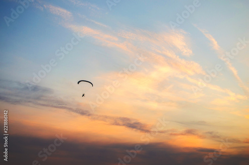 Ione paraglider flies high in the sky at sunset.Extreme sport. © freeman83