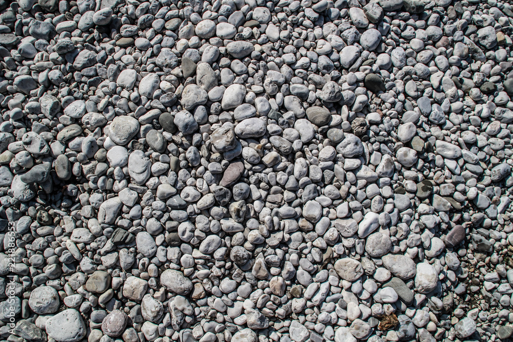 The texture of white river stones. The river of Slovenia with blue water The texture of white river stones. The river of Slovenia with blue water