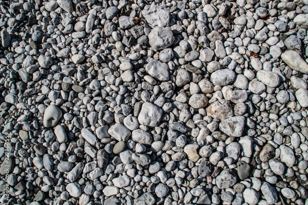 The texture of white river stones. The river of Slovenia with blue water The texture of white river stones. The river of Slovenia with blue water