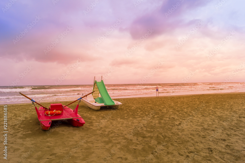 Fototapeta premium rescue boat at sunset at beach on a bad weather day