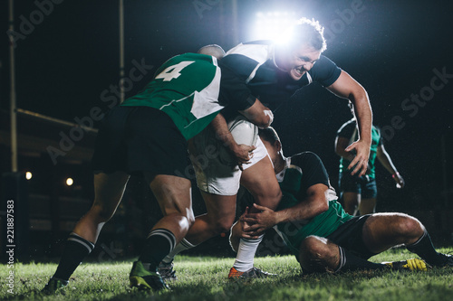 Rugby player trying to escape the tackle