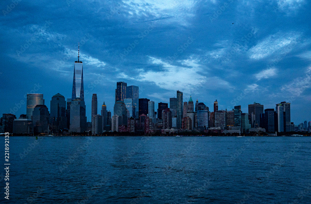 downtown Manhattan lighting up in the evening