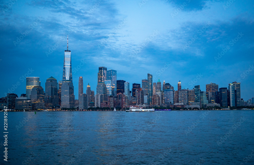 downtown Manhattan in the evening with boat