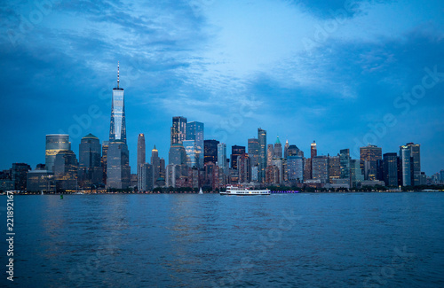 downtown Manhattan in the evening with boat © Michele
