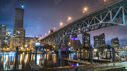 Granville Bridge along False Creek long exposure at night Vancouver BC. Vancouver is the third most populous metropolitan area and is the most ethnically diverse cities in Canada. photo
