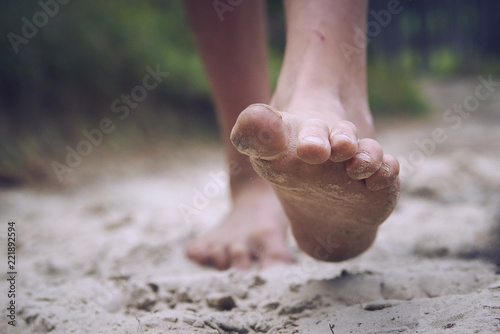 Photography Happy barefoot child walk alone by path, explore the forest