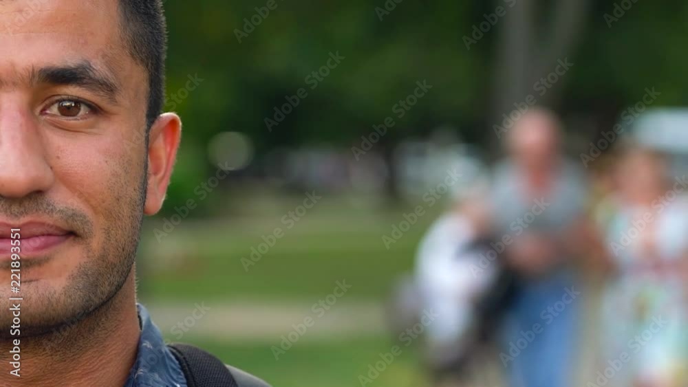 Portrait of a young Arab smiling man. Half face