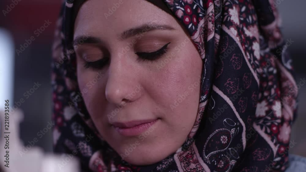 Up close view of ethnic woman wearing a headscarf as she looks up and smiles. Up close view of ethnic woman wearing a headscarf as she looks up and smiles.