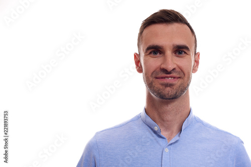 Casually handsome. Confident young handsome man in jeans shirt keeping arms crossed and smiling while standing against white background © Elena Kharichkina