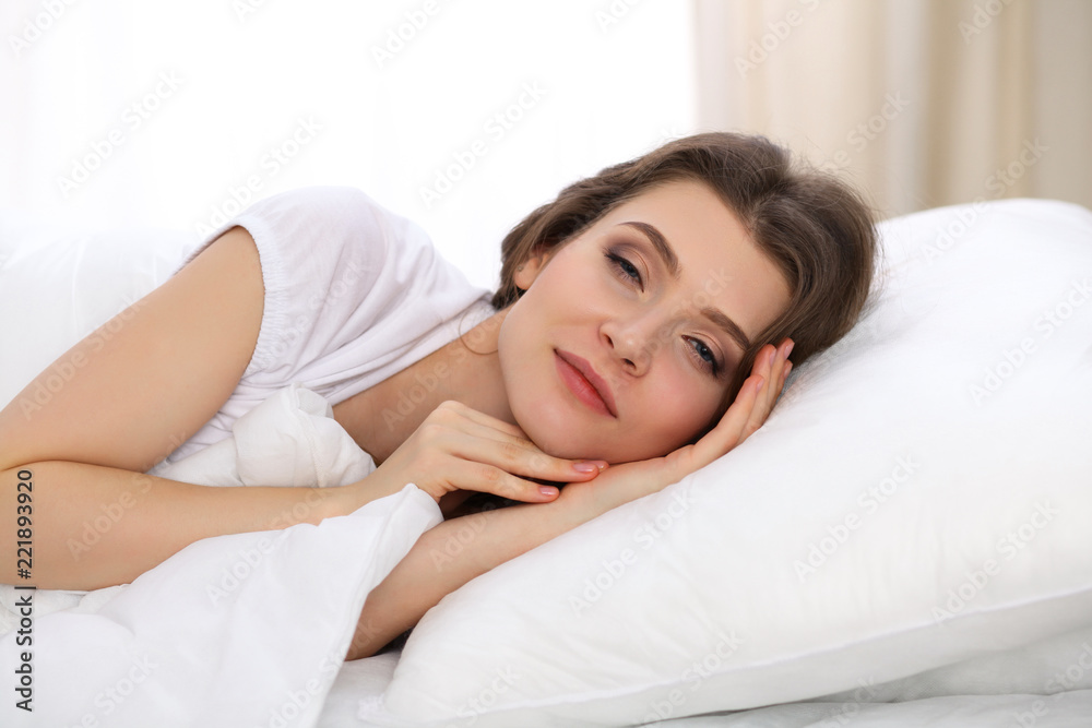 Beautiful young woman sleeping while lying in her bed. Concept of pleasant and rest reinstatement for active life Beautiful young woman sleeping while lying in her bed. Concept of pleasant and rest reinstatement for active life