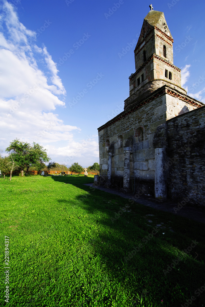 Densus Christian Church, built in 13th century AD, with stone blocks taken from the Roman city Ulpia Traiana Sarmisegetusa Densus Christian Church, built in 13th century AD, with stone blocks taken from the Roman city Ulpia Traiana Sarmisegetusa